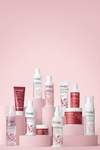 Collection of Advanced Climate Control® curly haired products on pink background