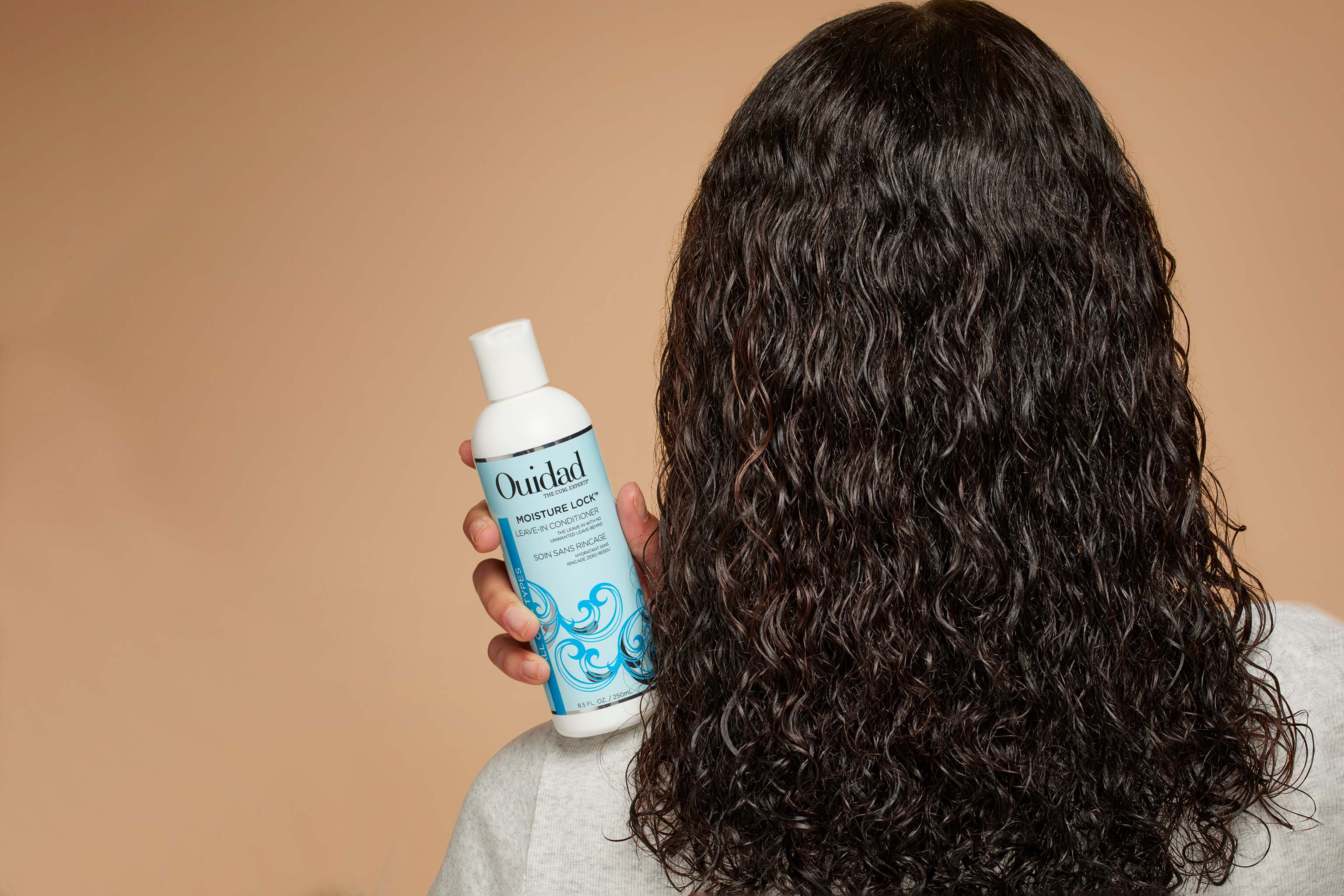 Model holding Moisture Lock® Leave-In Conditioner