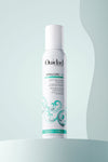 Bottle of VitalCurl®+ Soft Defining Mousse on light blue background