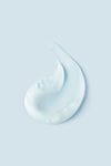 Portion of light blue Curl Quencher® Moisturizing Shampoo on light blue background